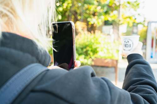 cell phone woman taking photo of white disposable cup mobile phone